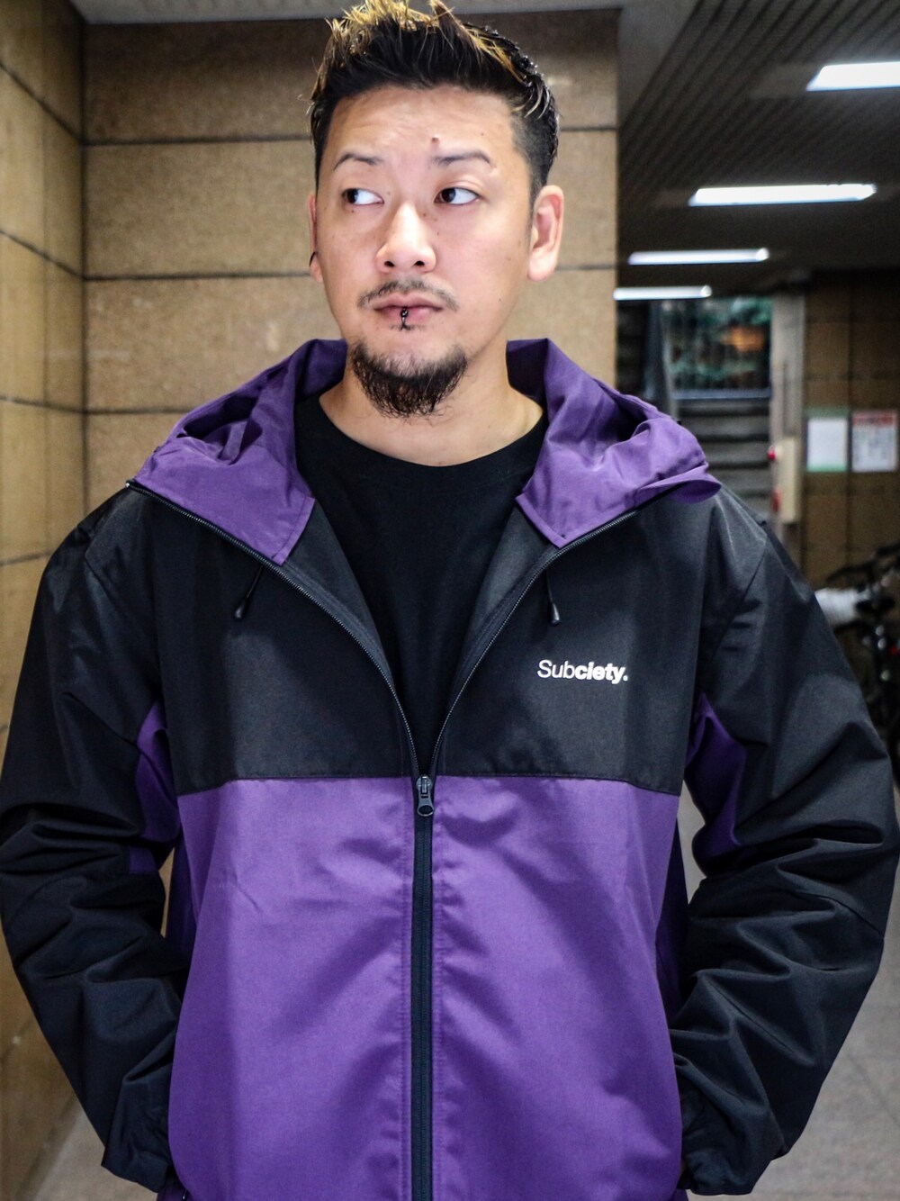 パープル系のマウンテンパーカーを着用したメンズの秋コーディネートの1枚目の写真