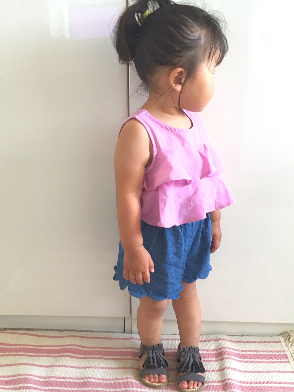 「1歳、次女、ピンク、フリンジ、ポニーテール、キッズコーデ」｜「petit mainのティアードフリルノースリーブTシャツ（Tシャツ/カットソー、ピンク系）」を使った、RiiiiijuuuunnnAさん（キッズ・100cm）の夏コーディネートの1枚目の写真