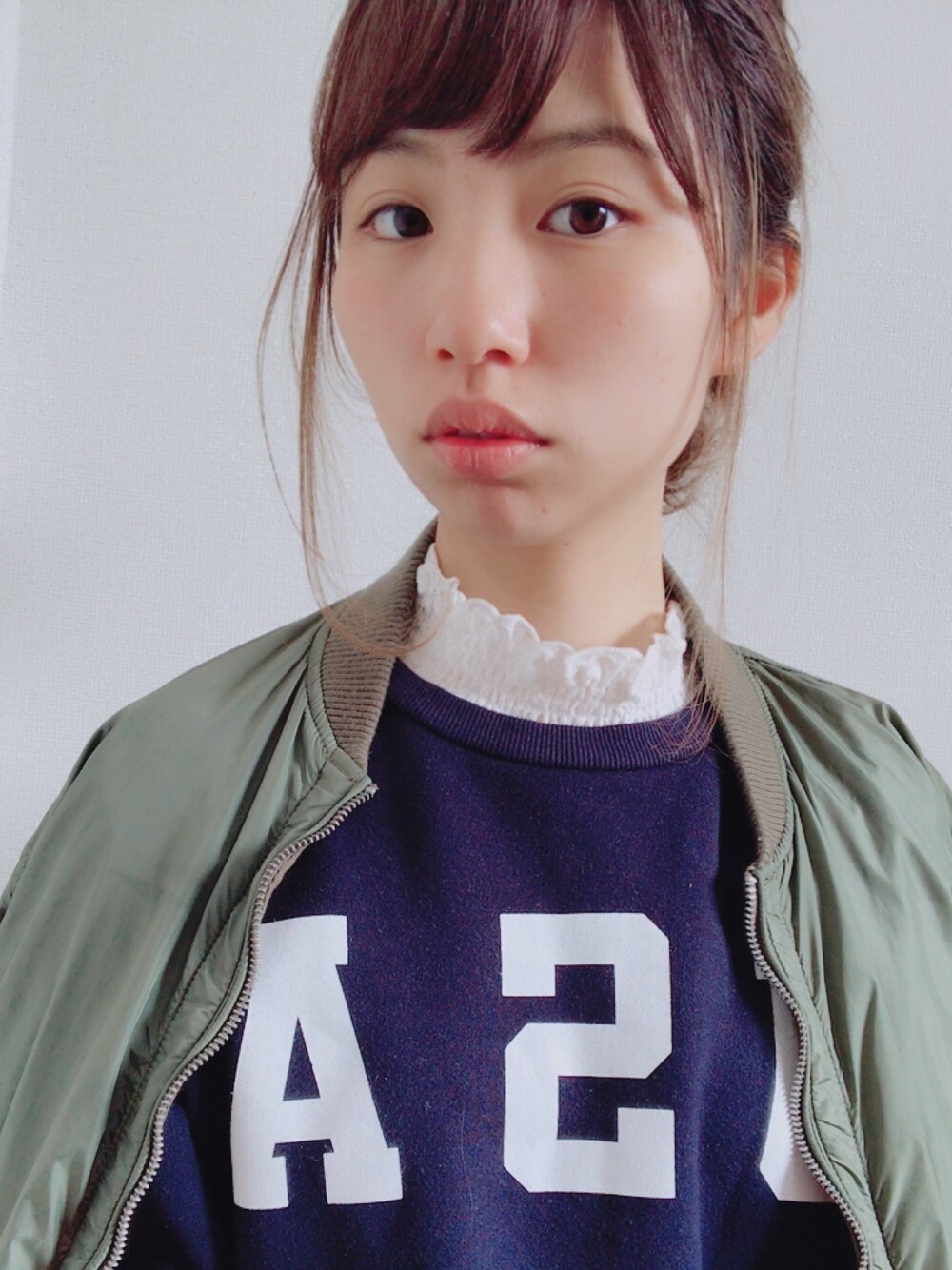ホワイト系のTシャツ/カットソー、ブルー系のスウェット、グリーン系のMA-1を着用したレディースの冬コーディネートの1枚目の写真