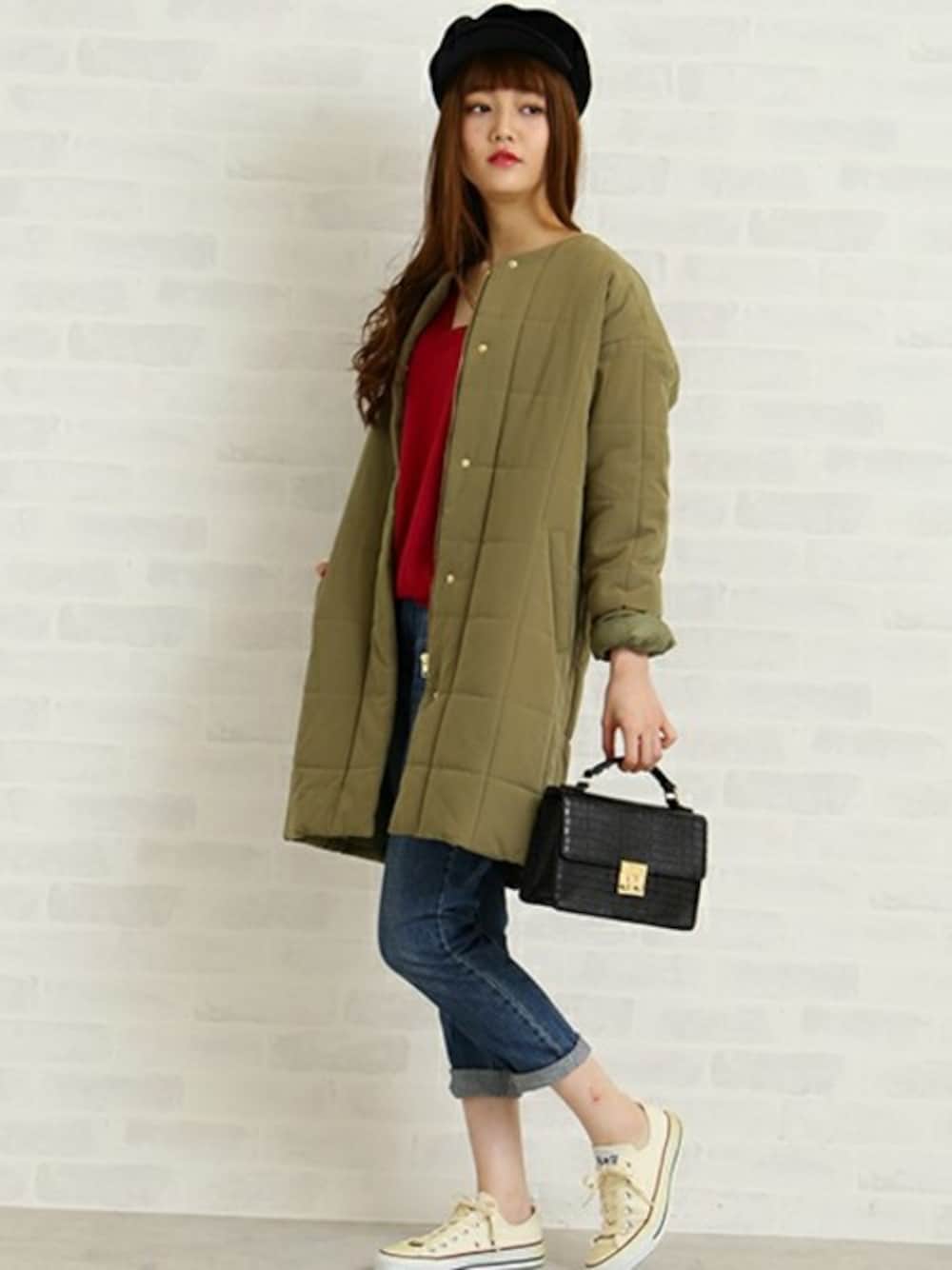 グリーン系のダウンジャケット/コート、ピンク系のニット/セーター、ブルー系のデニムパンツを着用したレディースの秋コーディネートの1枚目の写真