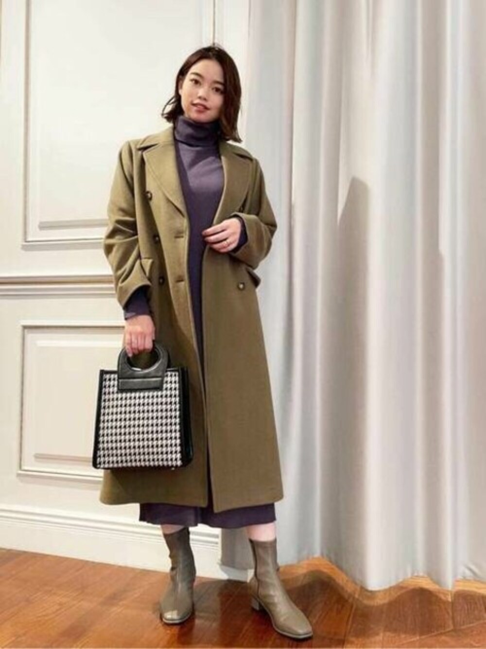 グリーン系のチェスターコート、パープル系のワンピース、ブラック系のトートバッグを着用したレディースの秋コーディネートの1枚目の写真