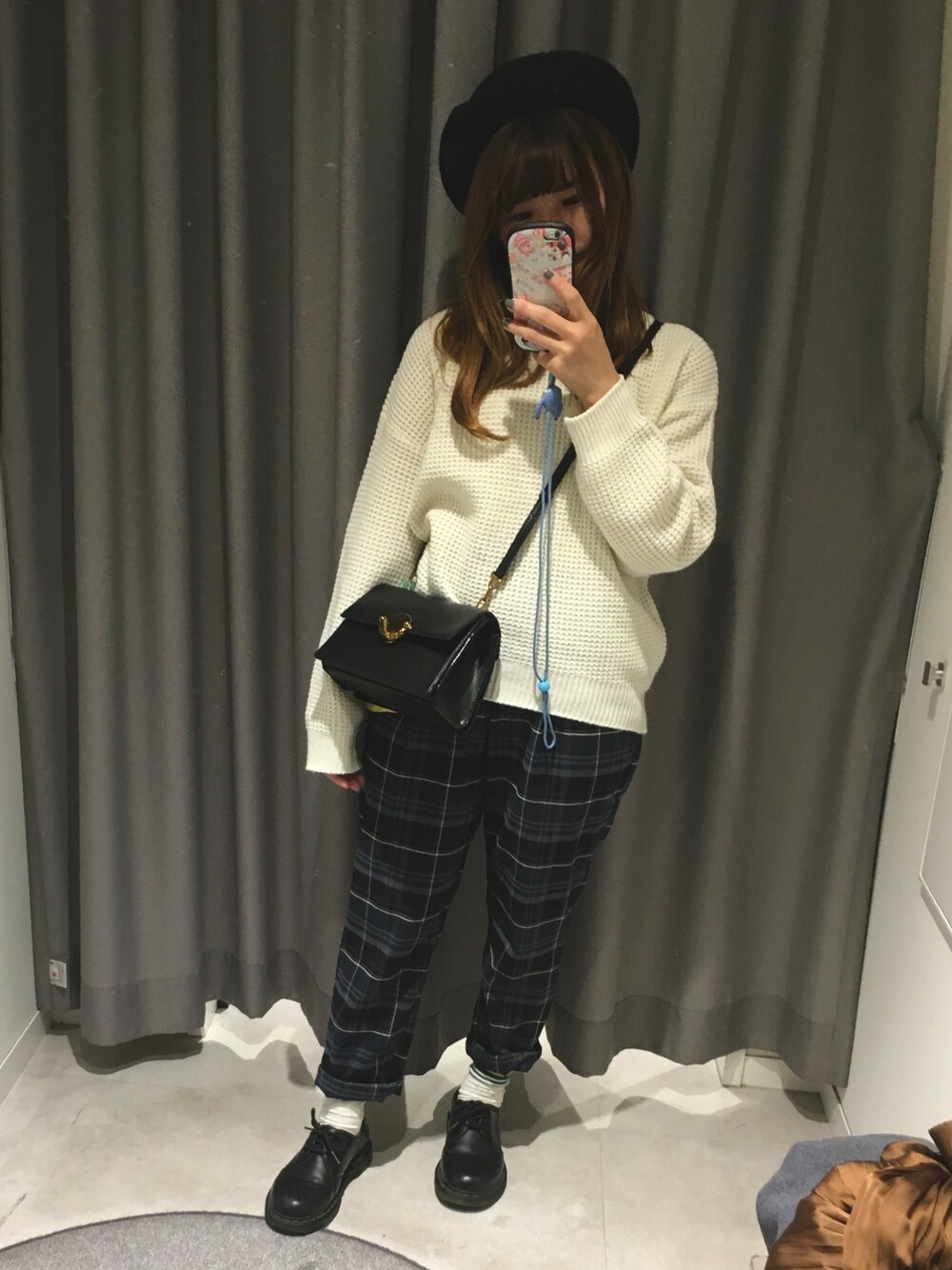 ブラック系のショルダーバッグ、グリーン系のチノパンツ、ホワイト系のニット/セーターを着用したレディースの秋コーディネートの1枚目の写真