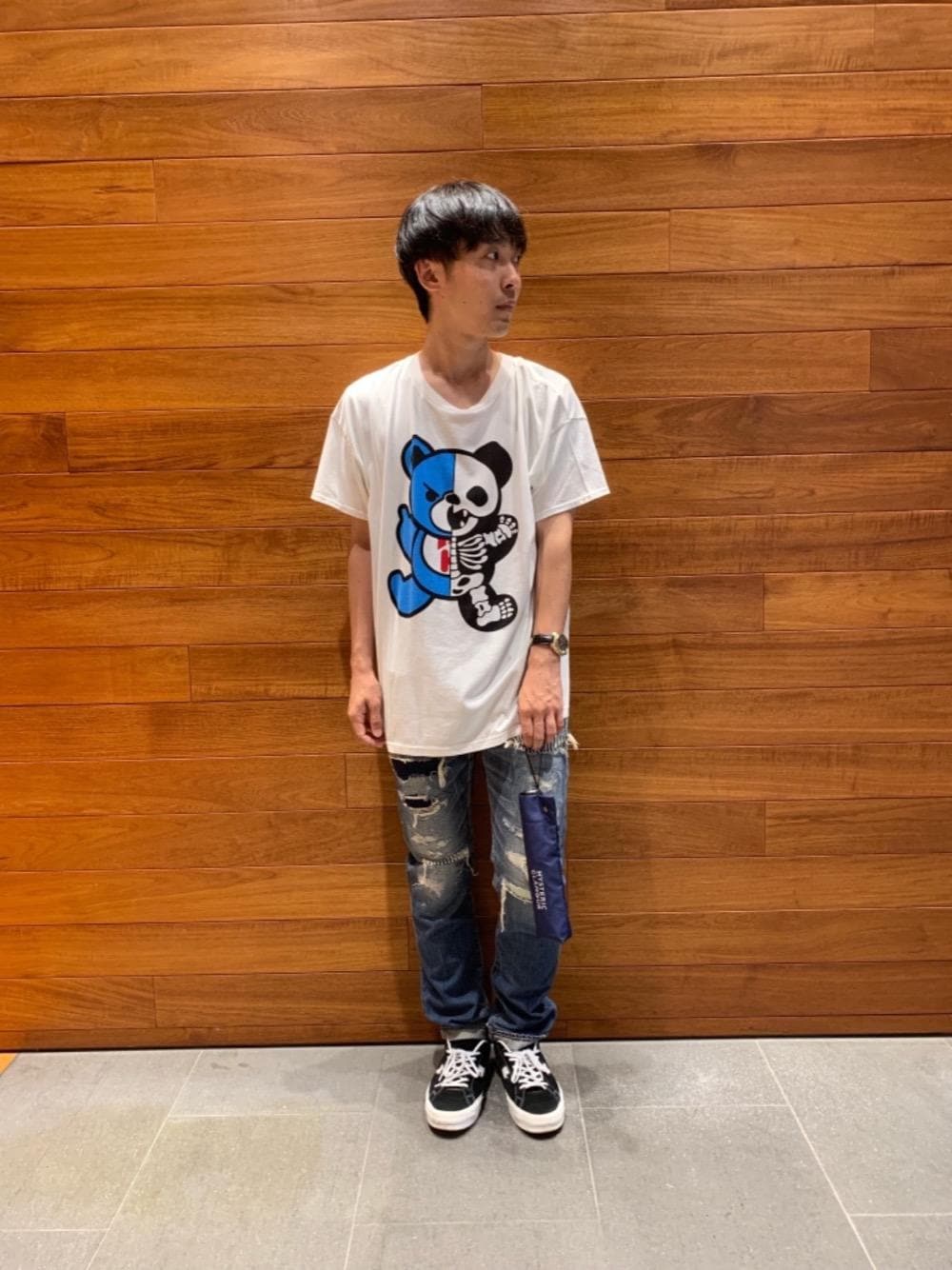 ホワイト系のTシャツ/カットソー、ブルー系のデニムパンツ、ブルー系の折りたたみ傘を着用したメンズの夏コーディネートの1枚目の写真