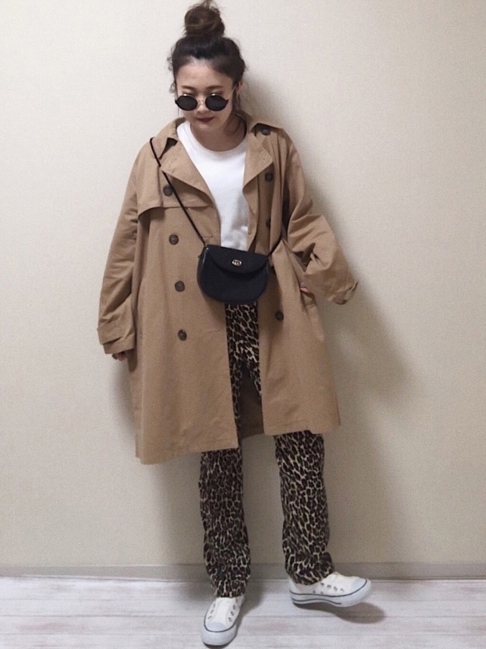 ホワイト系のスニーカー、ベージュ系のトレンチコート、ホワイト系のTシャツ/カットソーを着用したレディースの春コーディネートの1枚目の写真