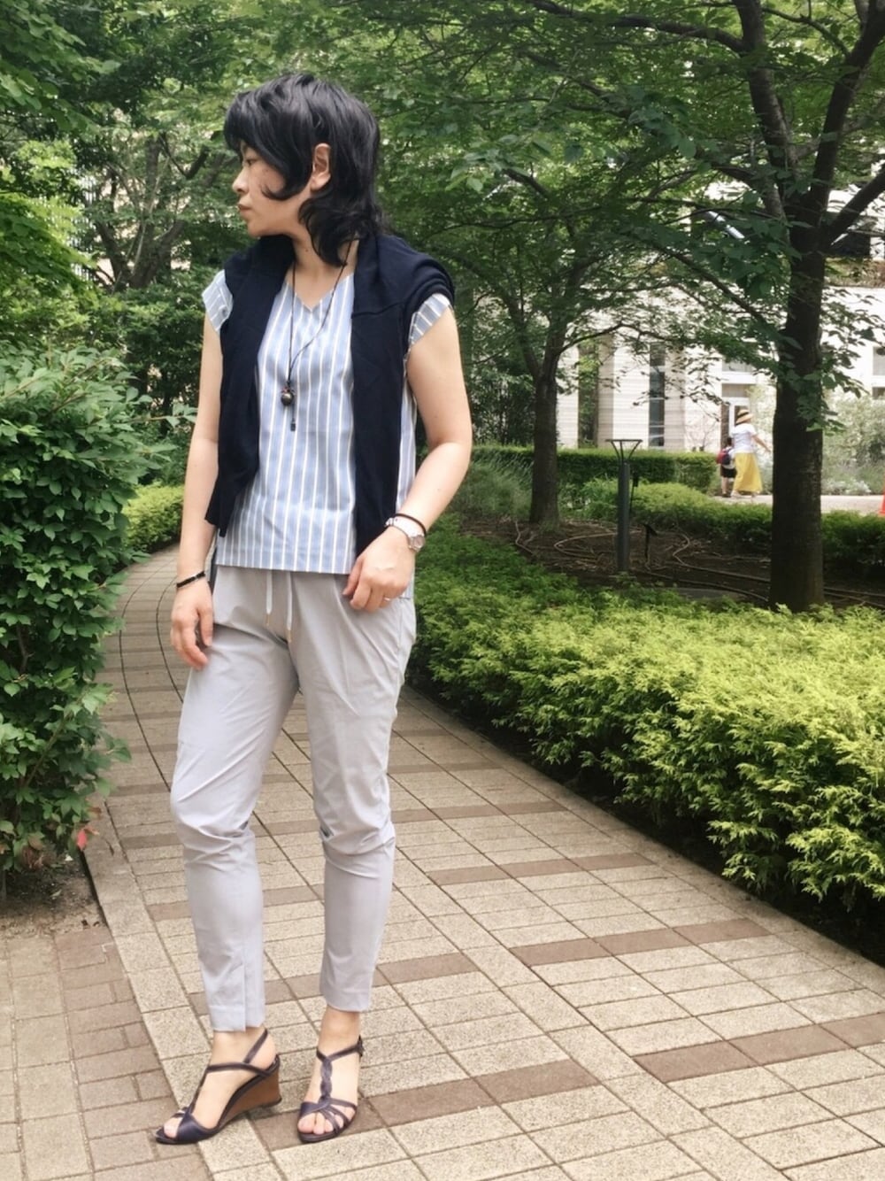 ブルー系のニット/セーター、ブルー系のシャツ/ブラウス、グレー系のその他パンツを着用したレディースの夏コーディネートの1枚目の写真