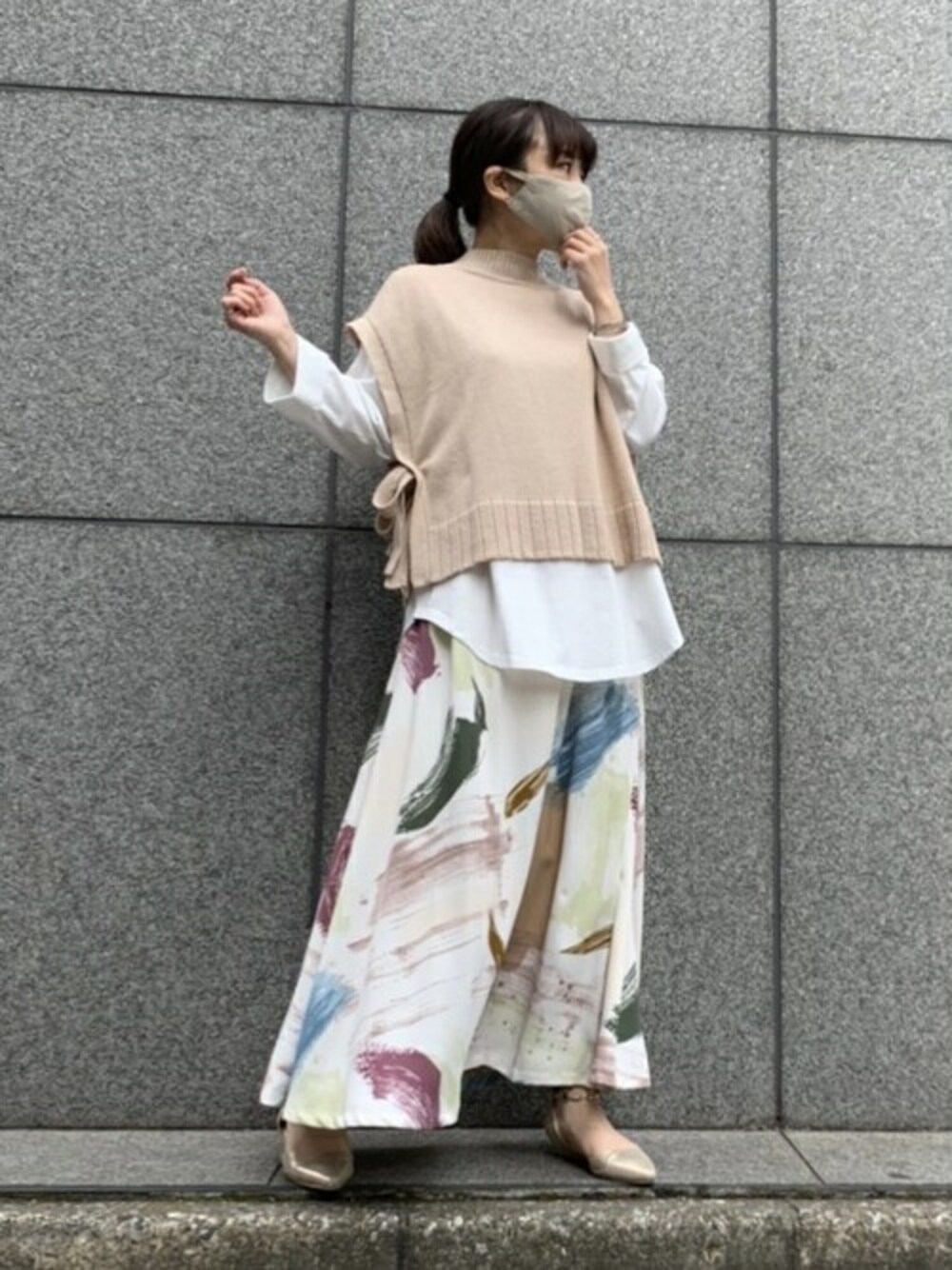 ベージュ系のスカートを着用したレディースの春コーディネートの1枚目の写真
