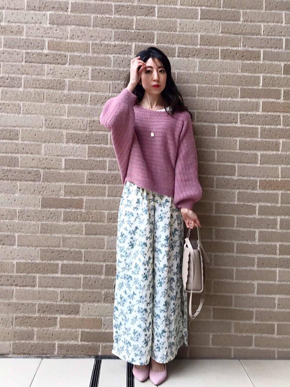 パープル系のニット/セーター、ホワイト系のその他パンツ、ベージュ系のショルダーバッグを着用したレディースの冬コーディネートの1枚目の写真