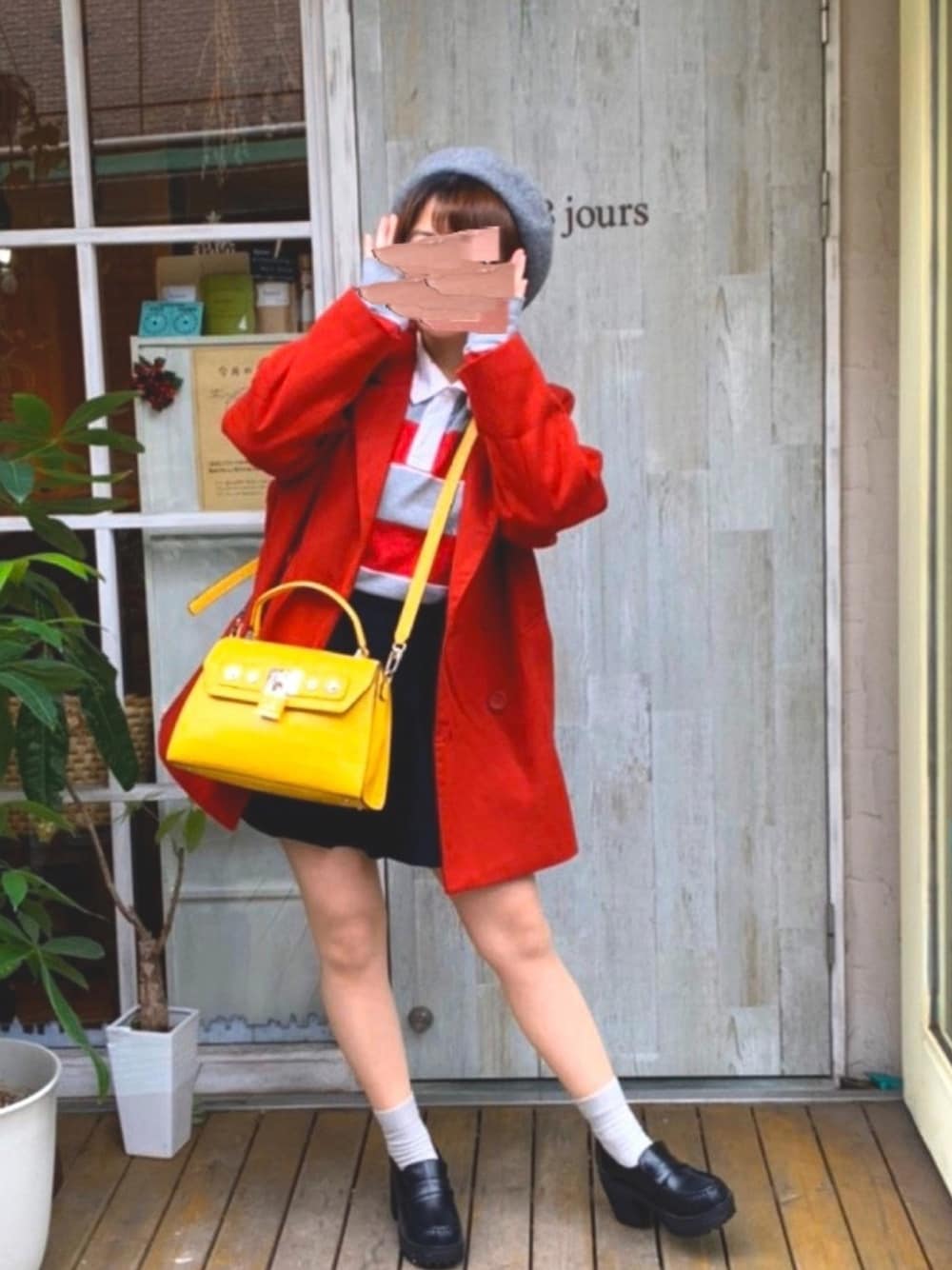 ブルー系のショルダーバッグ、ブラック系のローファー、レッド系のピーコートを着用したレディースの冬コーディネートの1枚目の写真