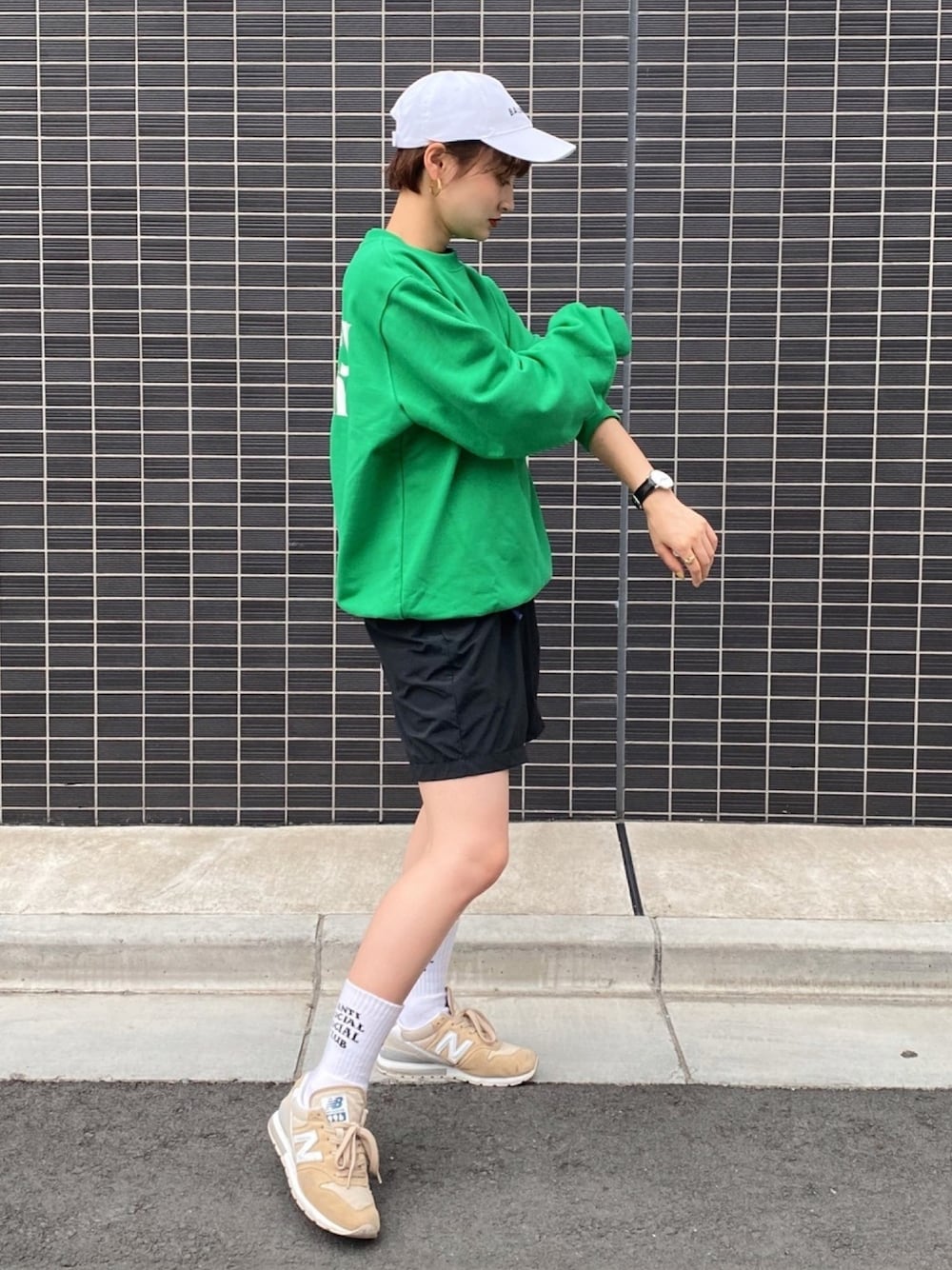 グリーン系のパーカー、ブラック系のその他パンツ、ベージュ系のスニーカーを着用したレディースの秋コーディネートの1枚目の写真