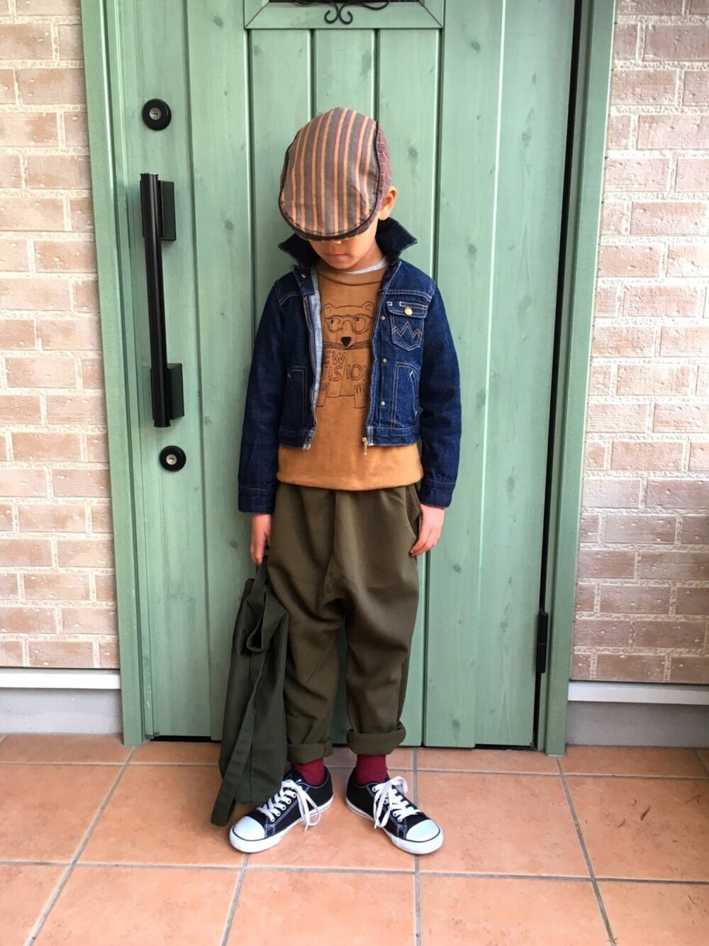 ベージュ系のスウェット、ブラック系のスニーカー、グリーン系のその他パンツを着用したキッズの冬コーディネートの1枚目の写真
