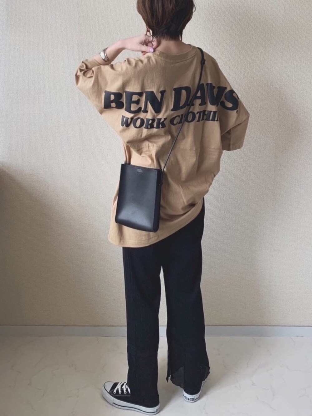 イエロー系のTシャツ/カットソー、ブラック系のその他パンツ、ブラック系のハンドバッグを着用したレディースの春コーディネートの1枚目の写真