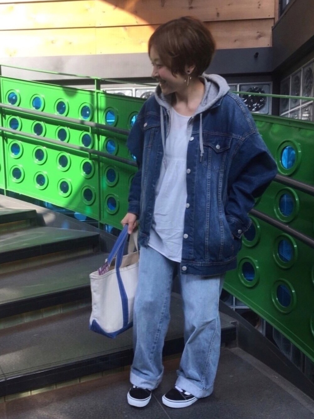 ブルー系のデニムジャケット、ホワイト系のシャツ/ブラウス、ブルー系のデニムパンツを着用したレディースの春コーディネートの1枚目の写真