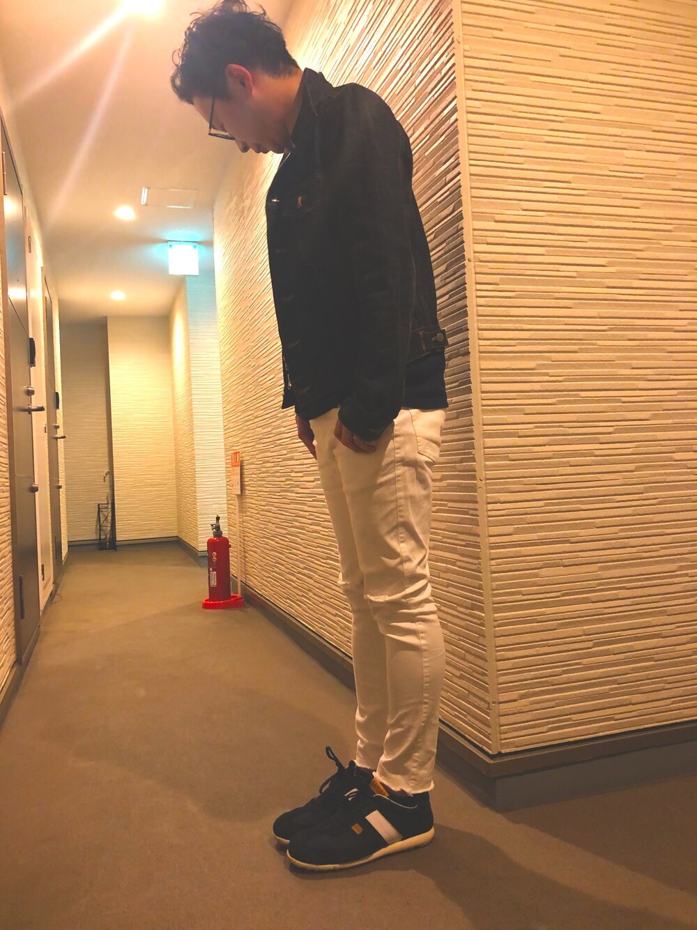 ホワイト系のパンツ、ブルー系のスニーカー、ブルー系のデニムジャケットを着用したメンズの春コーディネートの1枚目の写真