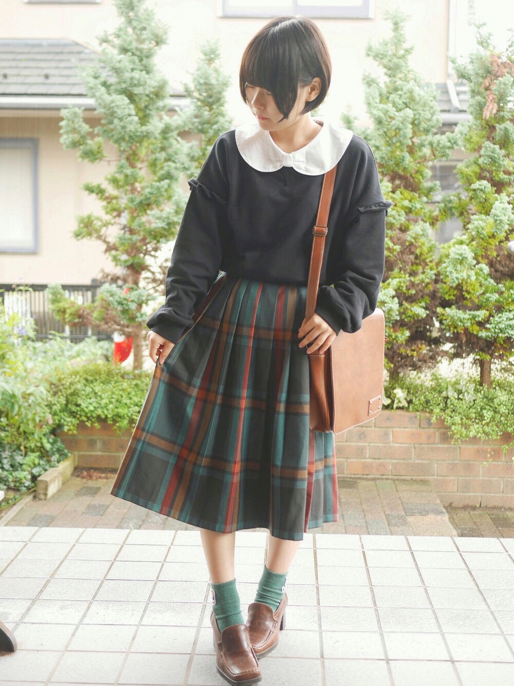 ブラック系のトップス、グリーン系のスカート、ホワイト系のシャツ/ブラウスを着用したレディースの秋コーディネートの1枚目の写真