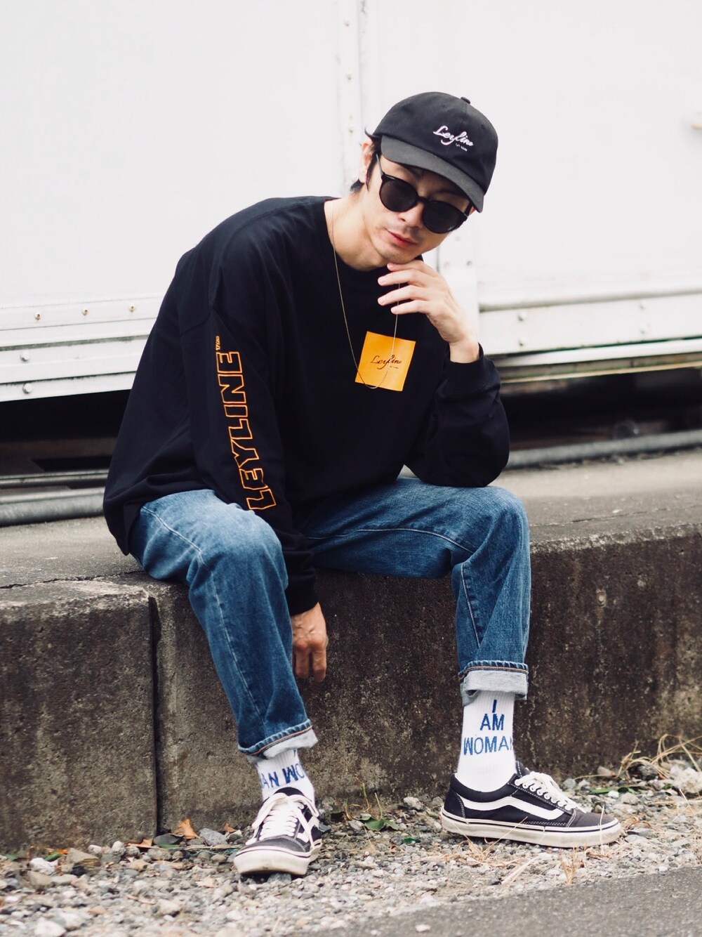 ブラック系のTシャツ/カットソー、ブルー系のデニムパンツ、ブラック系のスニーカーを着用したメンズの秋コーディネートの1枚目の写真