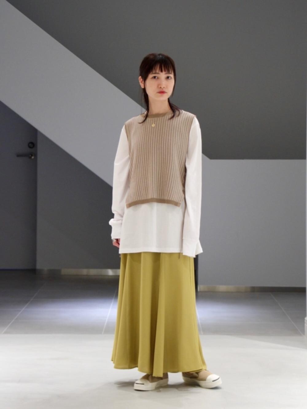 ホワイト系のTシャツ/カットソー、ベージュ系のスニーカー、イエロー系のスカートを着用したレディースの春コーディネートの1枚目の写真