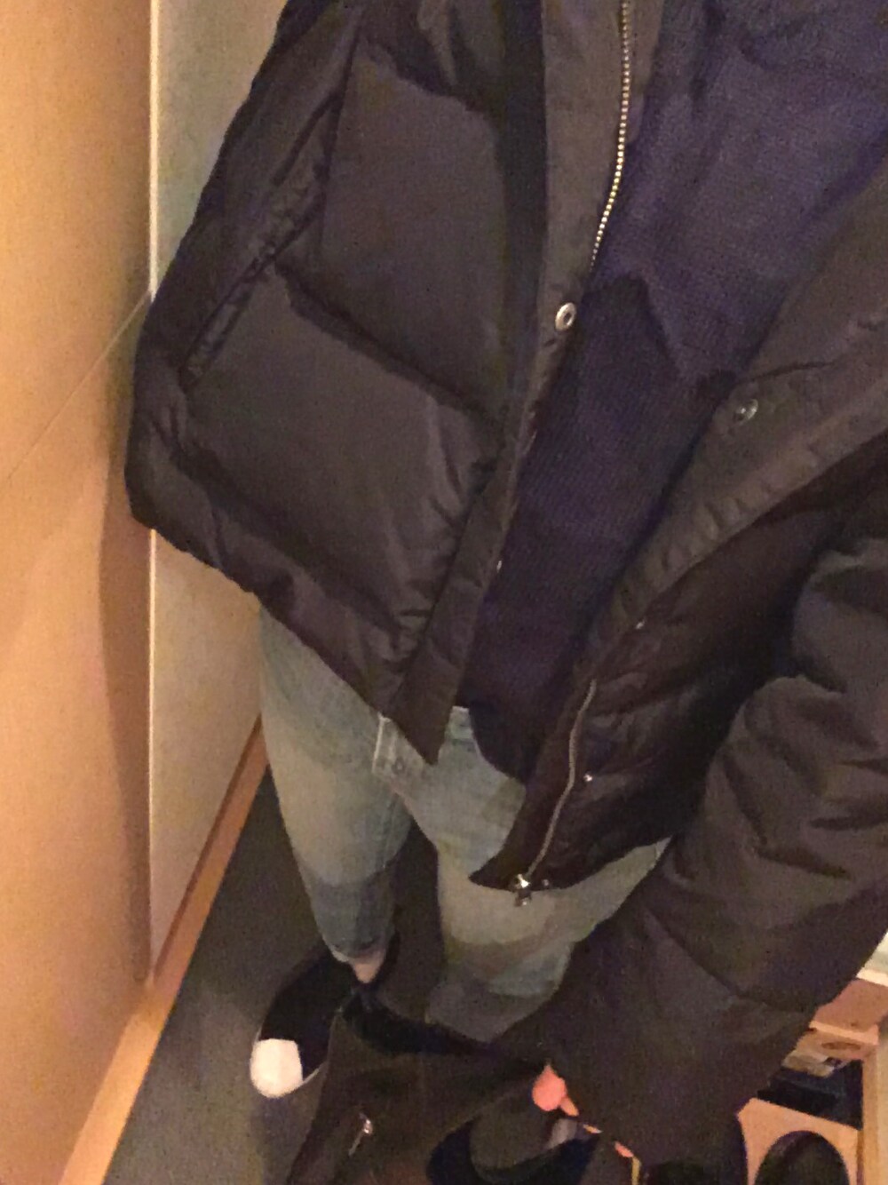 ブラック系のダウンジャケット/コート、ブルー系のデニムパンツ、ブラック系のスリッポンを着用したレディースの冬コーディネートの1枚目の写真