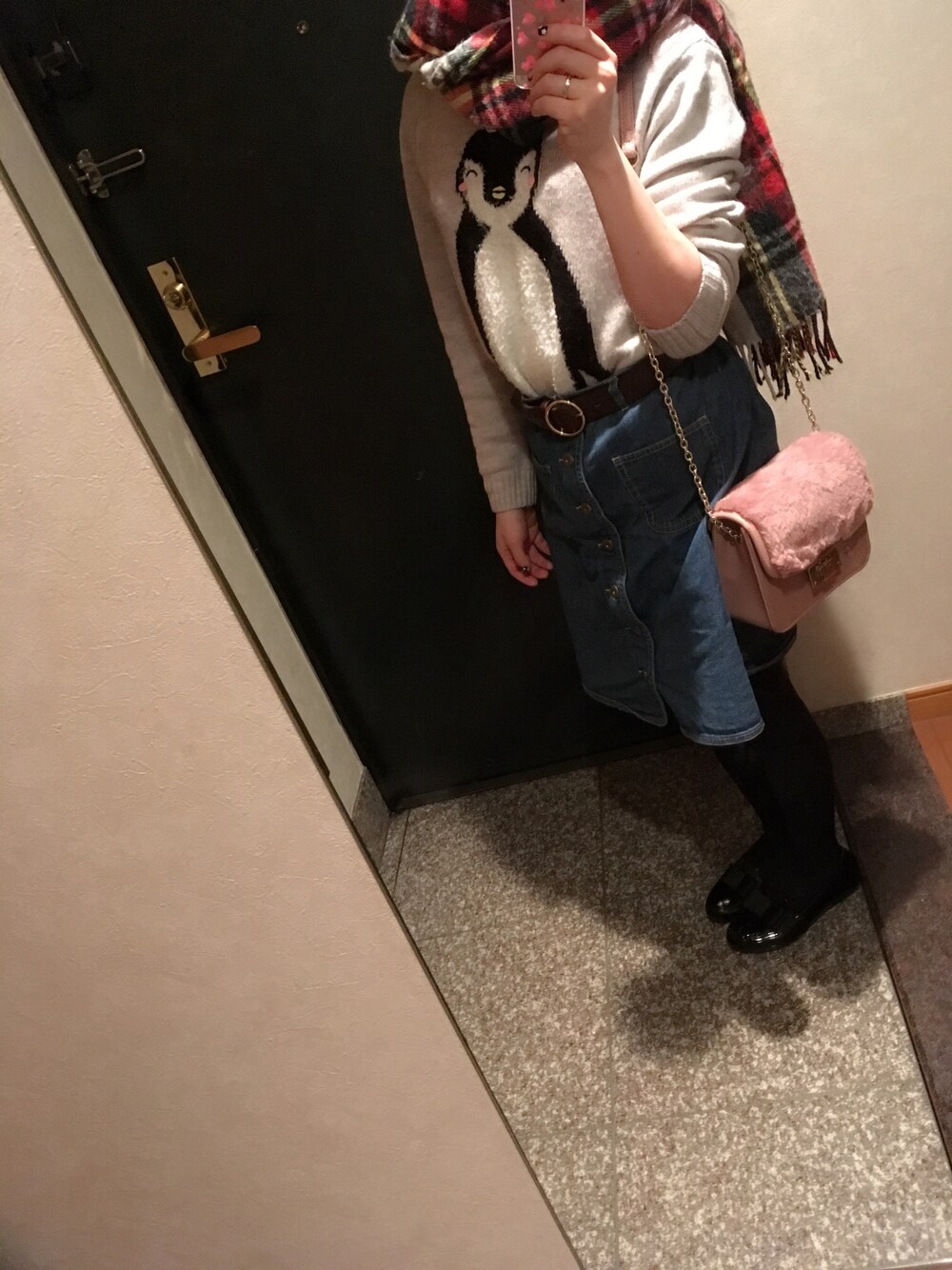 グレー系のニット/セーター、ブルー系のデニムスカート、ピンク系のトートバッグを着用したレディースの冬コーディネートの1枚目の写真