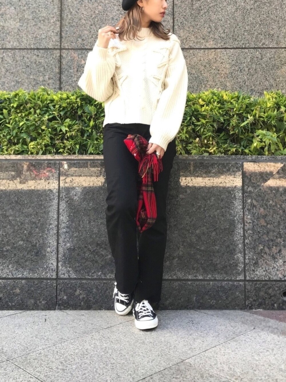 ブラック系のパンツ、ホワイト系のニット/セーター、レッド系のマフラーを着用したレディースの秋コーディネートの1枚目の写真