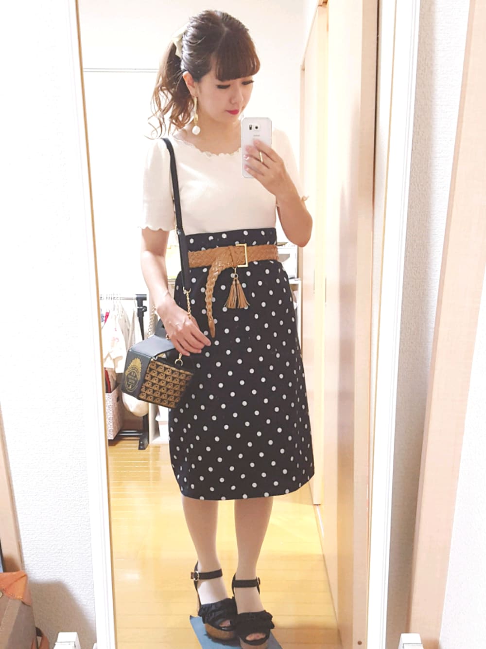 ホワイト系のTシャツ/カットソー、ブラック系のスカート、ブラック系のショルダーバッグを着用したレディースの夏コーディネートの1枚目の写真