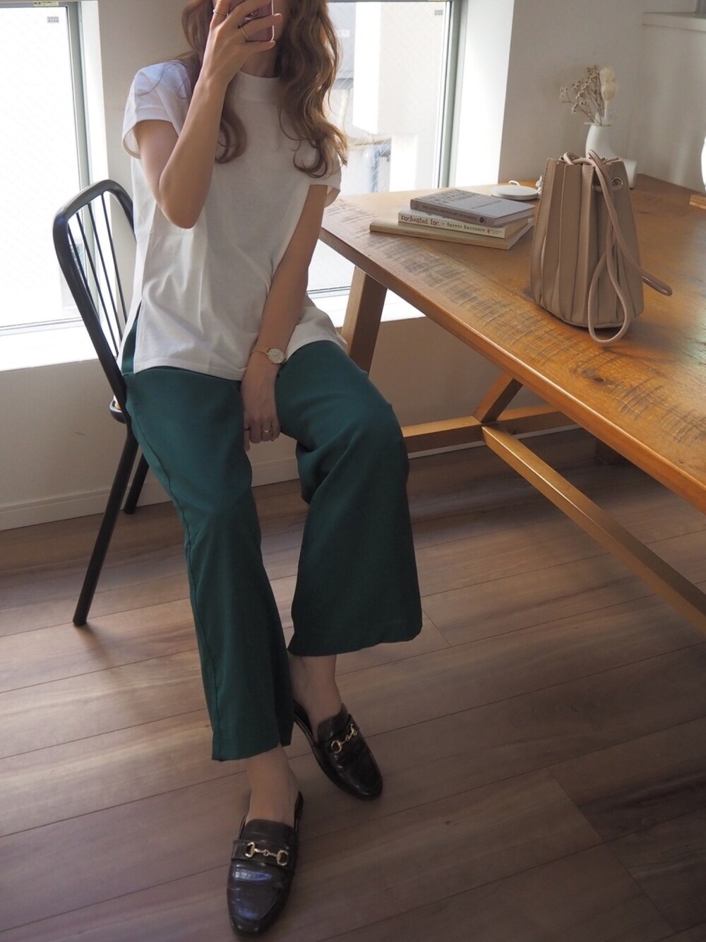 ホワイト系のTシャツ/カットソー、グリーン系のスラックス、ブラック系のサンダルを着用したレディースの春コーディネートの1枚目の写真