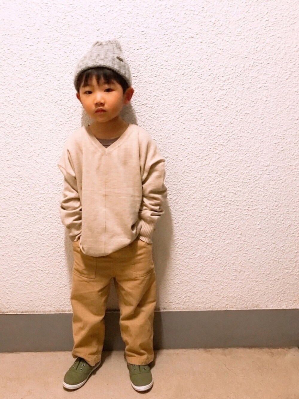 ベージュ系のニット/セーター、ベージュ系のその他パンツ、ホワイト系のスリッポンを着用したキッズの冬コーディネートの1枚目の写真