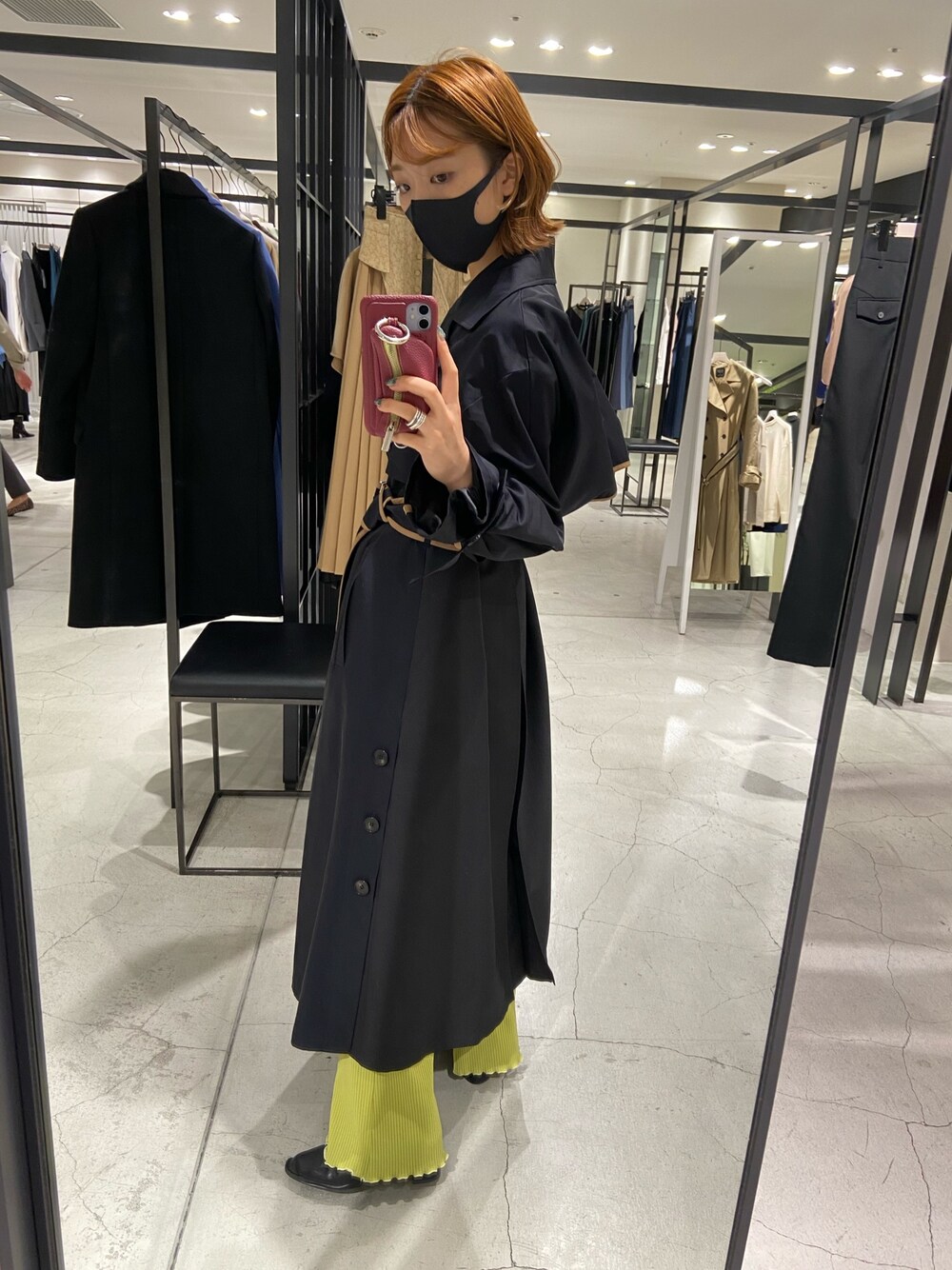 ブラック系のトレンチコート、グリーン系のその他パンツを着用したレディースの秋コーディネートの1枚目の写真