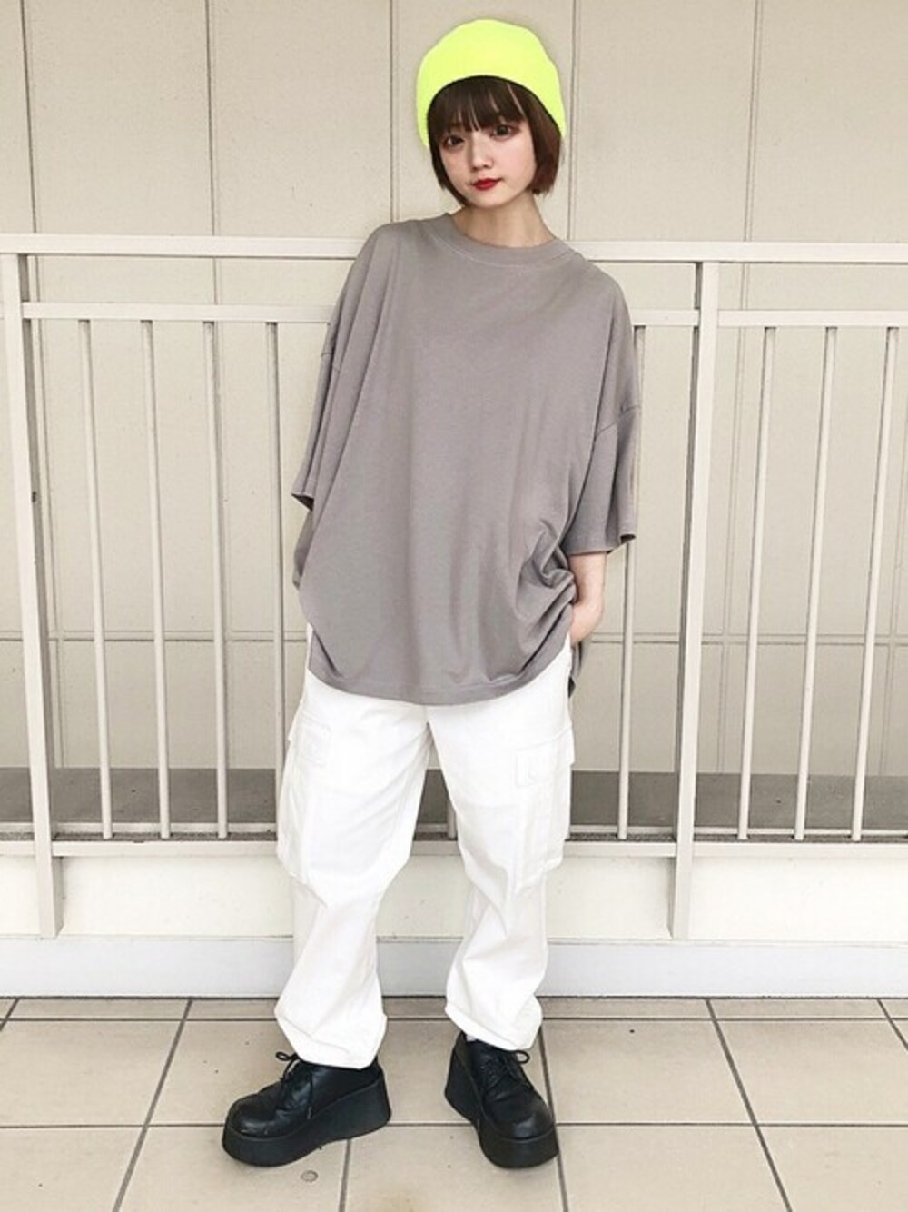ホワイト系のカーゴパンツ、グレー系のTシャツ/カットソー、イエロー系のニットキャップ/ビーニーを着用したレディースの夏コーディネートの1枚目の写真