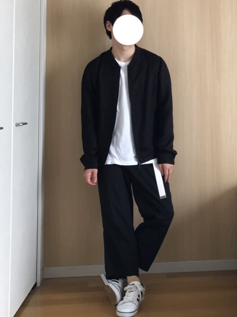 ブラック系のブルゾン、ホワイト系のTシャツ/カットソー、ブラック系のスラックスを着用したメンズの秋コーディネートの1枚目の写真