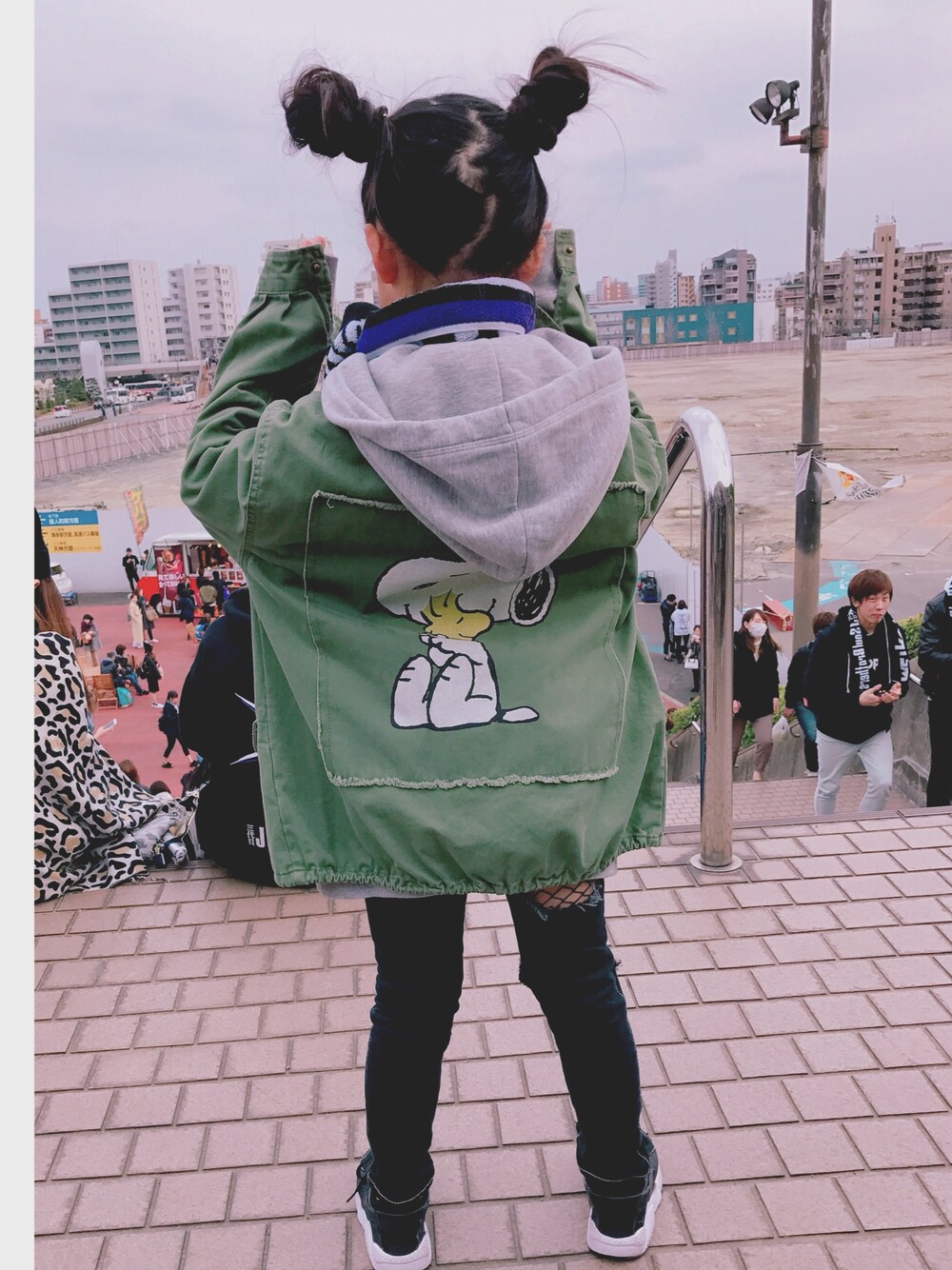 グリーン系のミリタリージャケット、ブラック系のスニーカー、パープル系のファッション雑貨を着用したキッズの春コーディネートの1枚目の写真