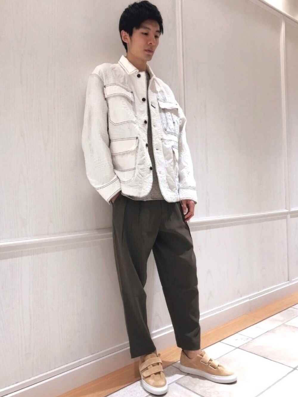 ホワイト系のジャケット/アウター、グリーン系のパンツ、グレー系のニット/セーターを着用したレディースの冬コーディネートの1枚目の写真