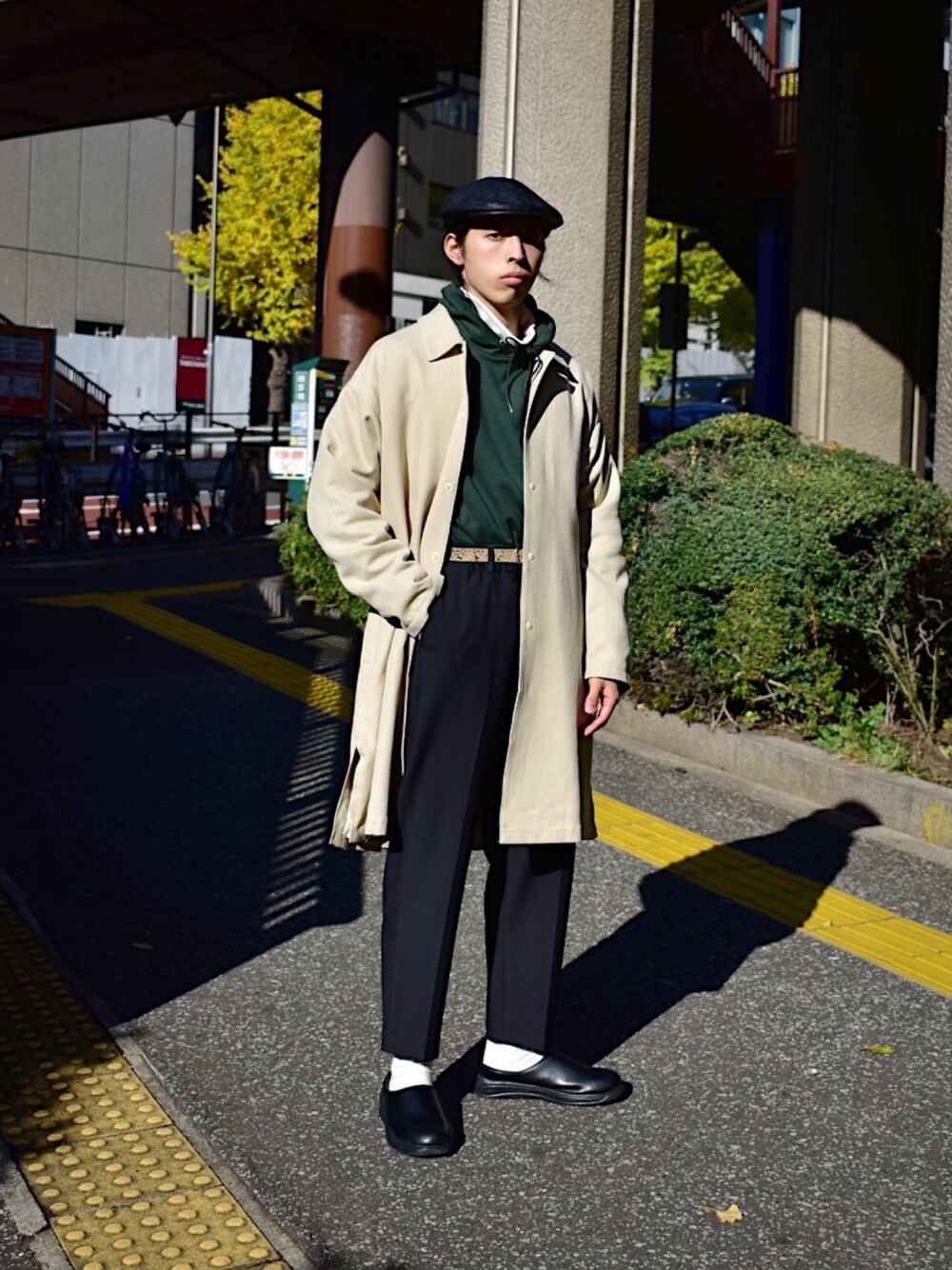 グリーン系のパーカー、ホワイト系のTシャツ/カットソー、ベージュ系のステンカラーコートを着用したメンズの冬コーディネートの1枚目の写真