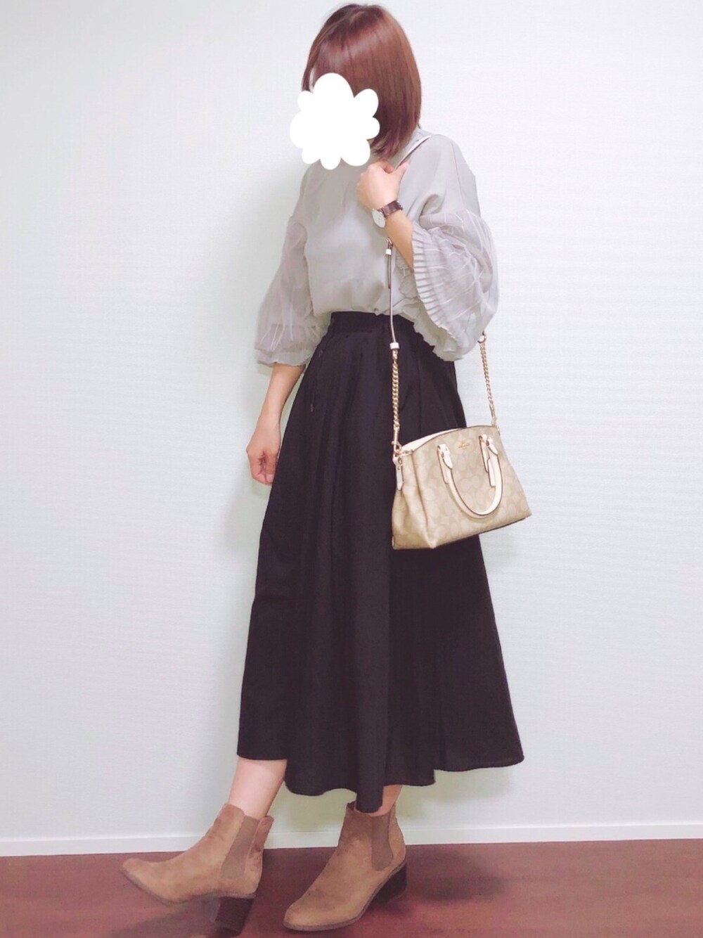 グレー系のシャツ/ブラウス、ブラック系のスカート、ブラウン系のブーツを着用したレディースの秋コーディネートの1枚目の写真