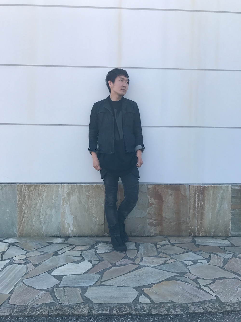 ブルー系のデニムジャケット、ブラック系のデニムパンツ、ブラック系のスニーカーを着用したメンズの春コーディネートの1枚目の写真