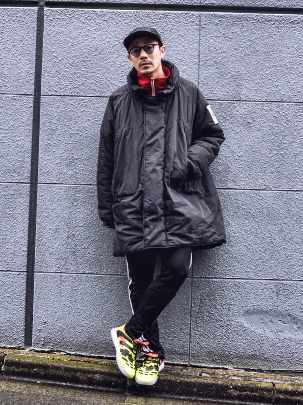 ブラック系のダウンジャケット/コート、ブラック系のその他パンツ、イエロー系のスニーカーを着用したメンズの冬コーディネートの1枚目の写真