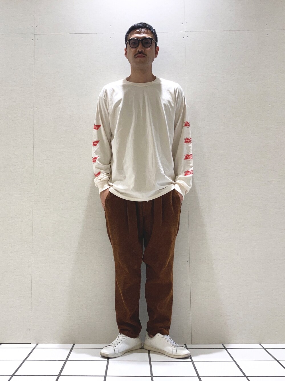 ベージュ系のTシャツ/カットソー、ブラウン系のその他パンツを着用したメンズの秋コーディネートの1枚目の写真