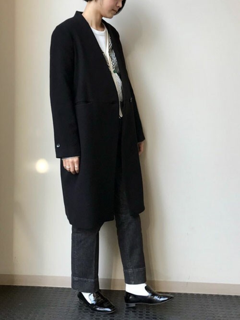 ブラック系のその他アウター、ホワイト系のTシャツ/カットソー、ブラック系のデニムパンツを着用したレディースの冬コーディネートの1枚目の写真