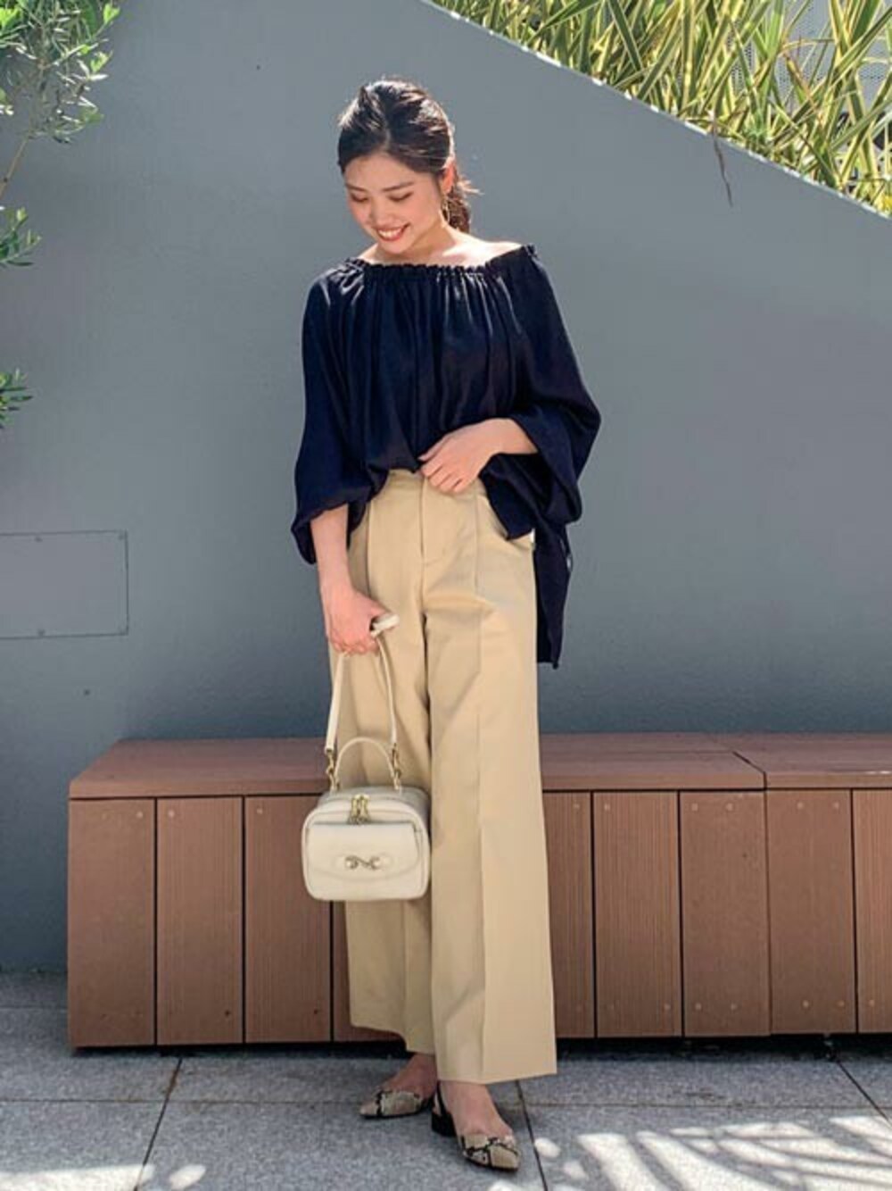 ブラック系のシャツ/ブラウス、ベージュ系のスラックスを着用したレディースの夏コーディネートの1枚目の写真