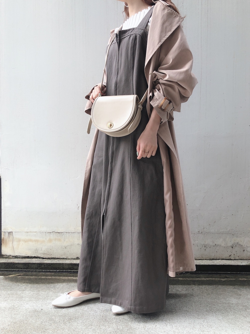 グレー系のワンピース、ホワイト系のバレエシューズ、ホワイト系のニット/セーターを着用したレディースの春コーディネートの1枚目の写真