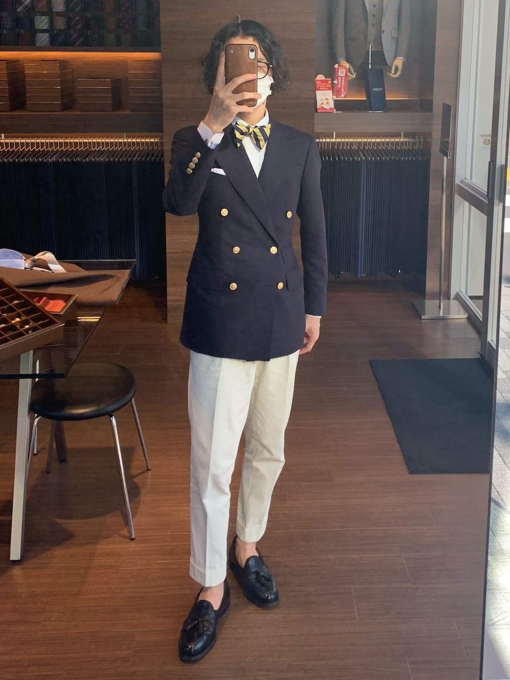 ブラック系のローファー、イエロー系の蝶ネクタイを着用したメンズの夏コーディネートの1枚目の写真