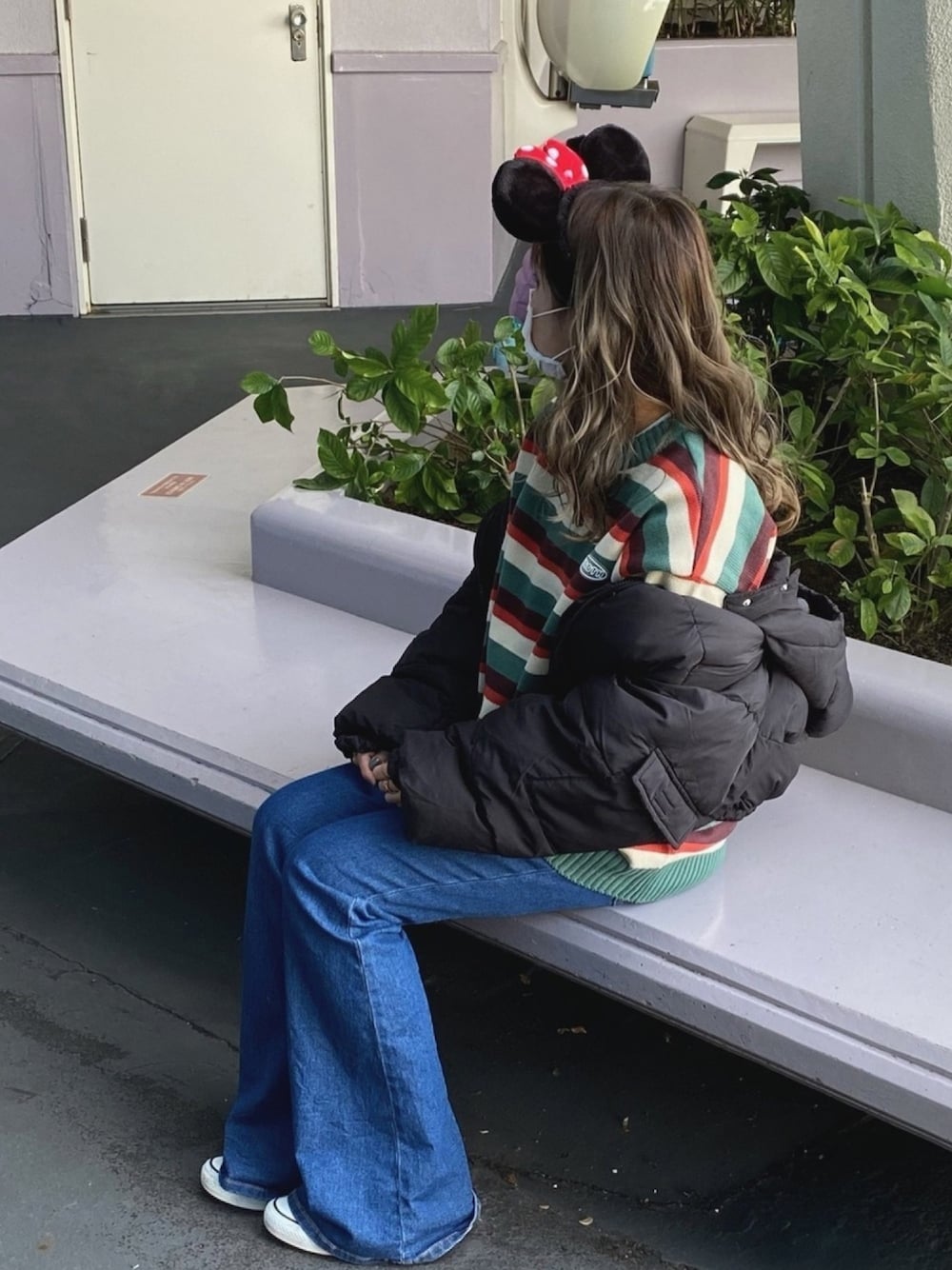 ブラック系のダウンジャケット/コート、ブルー系のデニムパンツ、ブラック系のスニーカーを着用したレディースの冬コーディネートの1枚目の写真