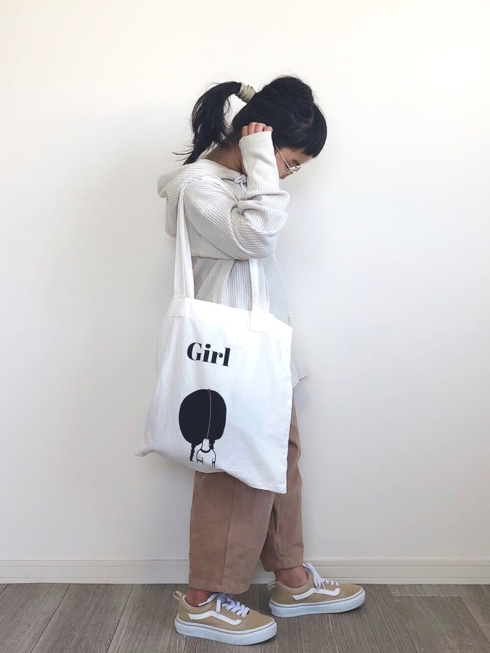 ホワイト系のパーカー、ブラウン系のパンツ、ベージュ系のスニーカーを着用したキッズの春コーディネートの1枚目の写真