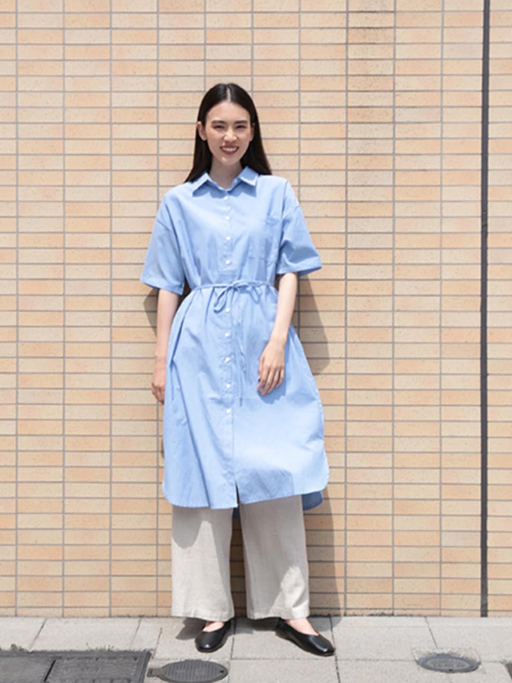 ブルー系のシャツワンピースを着用したレディースの春コーディネートの1枚目の写真