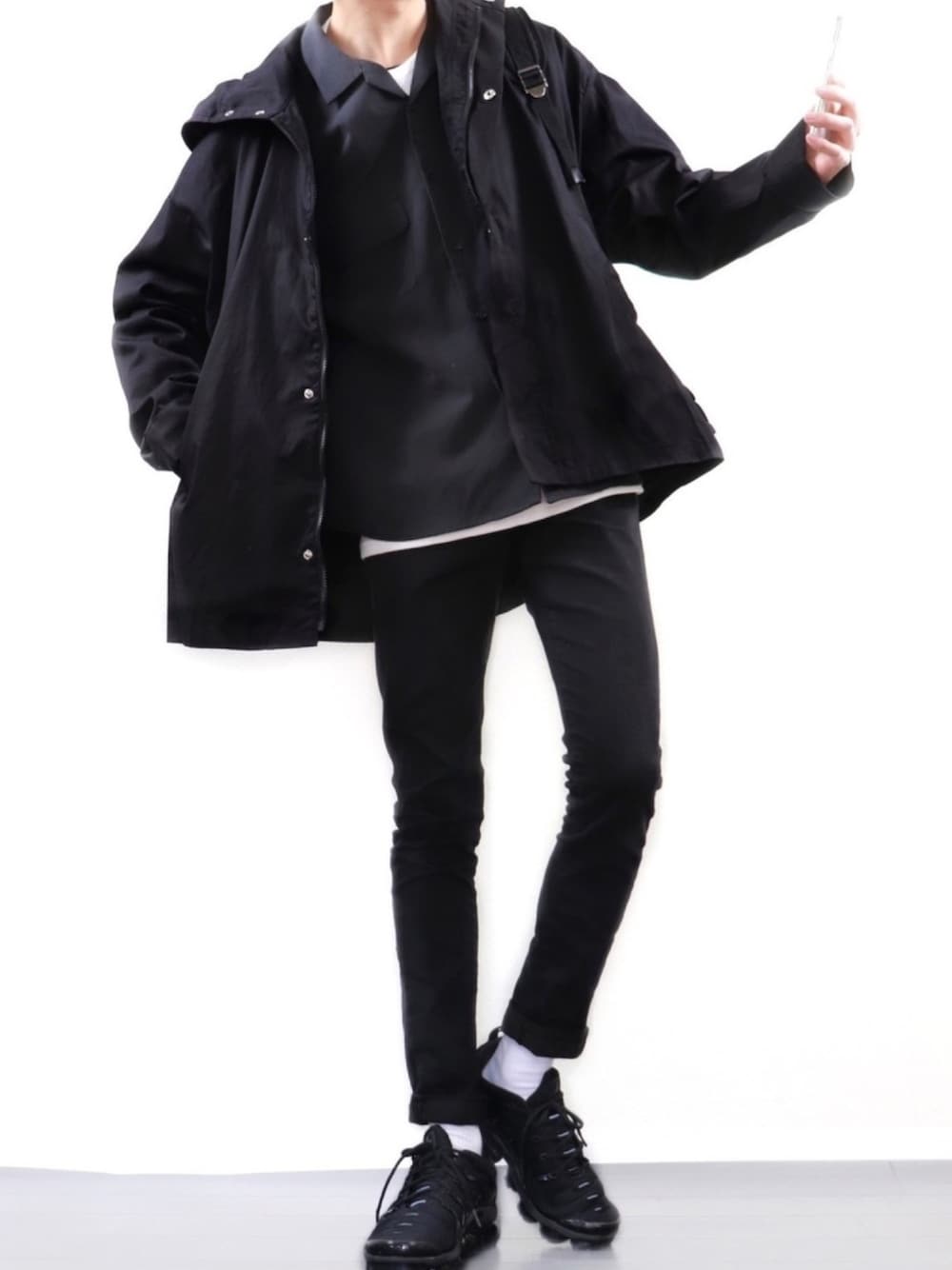 ブラック系のマウンテンパーカー、ブラック系のシャツ/ブラウス、ホワイト系のTシャツ/カットソーを着用したメンズの春コーディネートの1枚目の写真