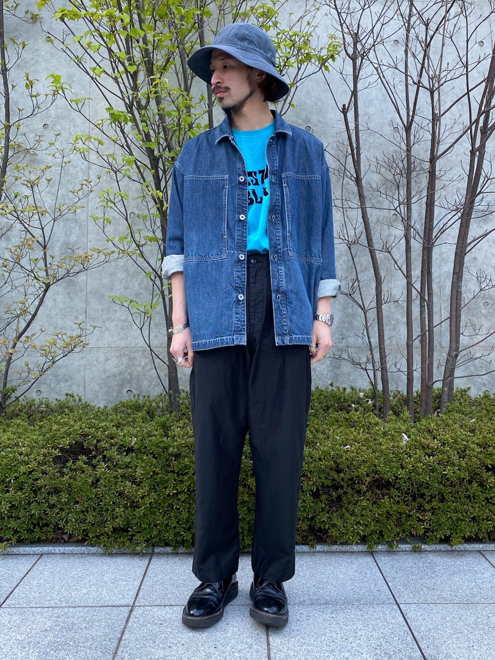 ブルー系のデニムジャケット、ブルー系のTシャツ/カットソー、ブラック系のパンツを着用したメンズの春コーディネートの1枚目の写真