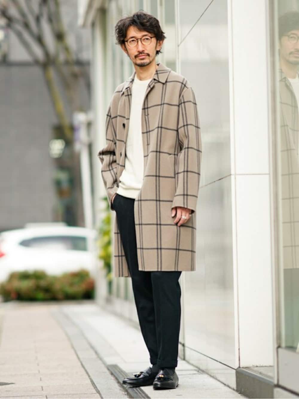 ベージュ系のステンカラーコート、ホワイト系のニット/セーター、ブラック系のその他パンツを着用したメンズの冬コーディネートの1枚目の写真