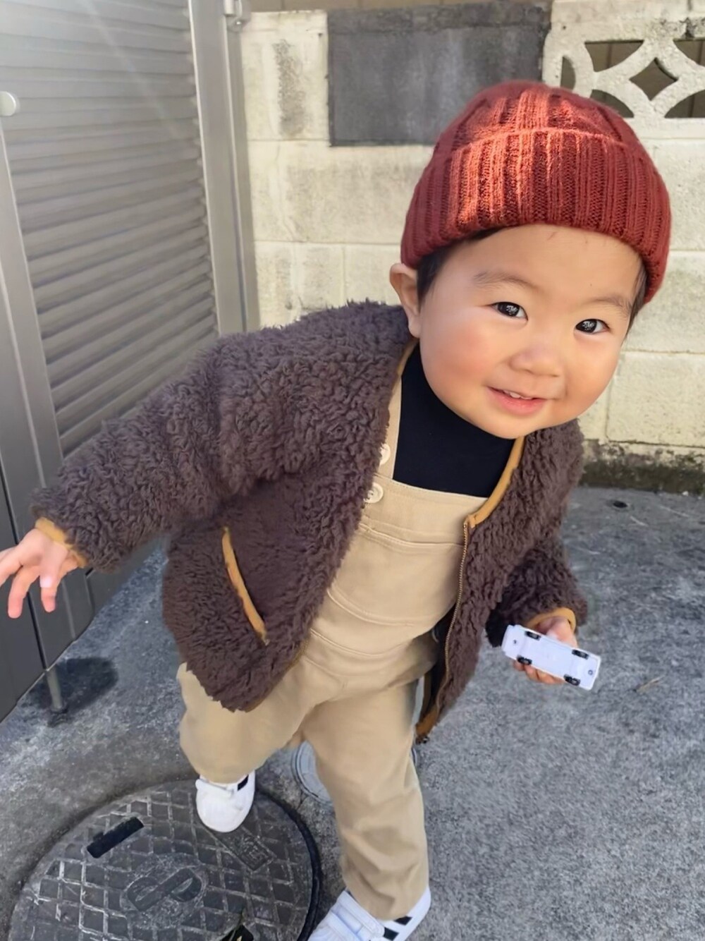 「1歳、サロペット、オーバーオール、モコモコアウター、あったかコーデ、ブラウン、ベージュ、ニット帽、差し色(赤)、着回しコーデ」｜「無印良品のアイテム（オールインワン・サロペット、ベージュ系）」を使った、KotaMashi6さん（キッズ・80cm）の冬コーディネートの1枚目の写真