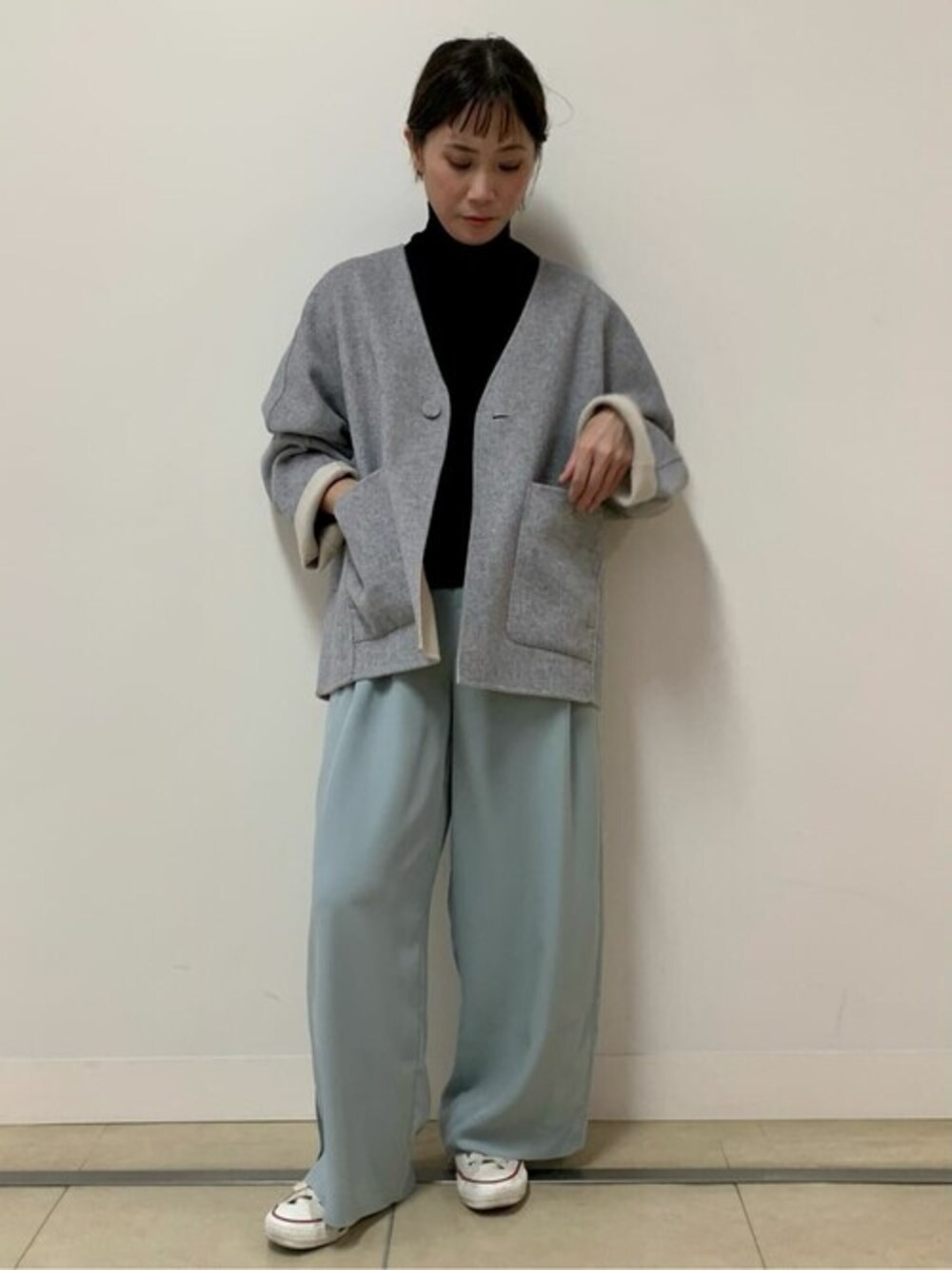 ホワイト系のノーカラーコート、ブラック系のニット/セーター、グリーン系のその他パンツを着用したレディースの秋コーディネートの1枚目の写真