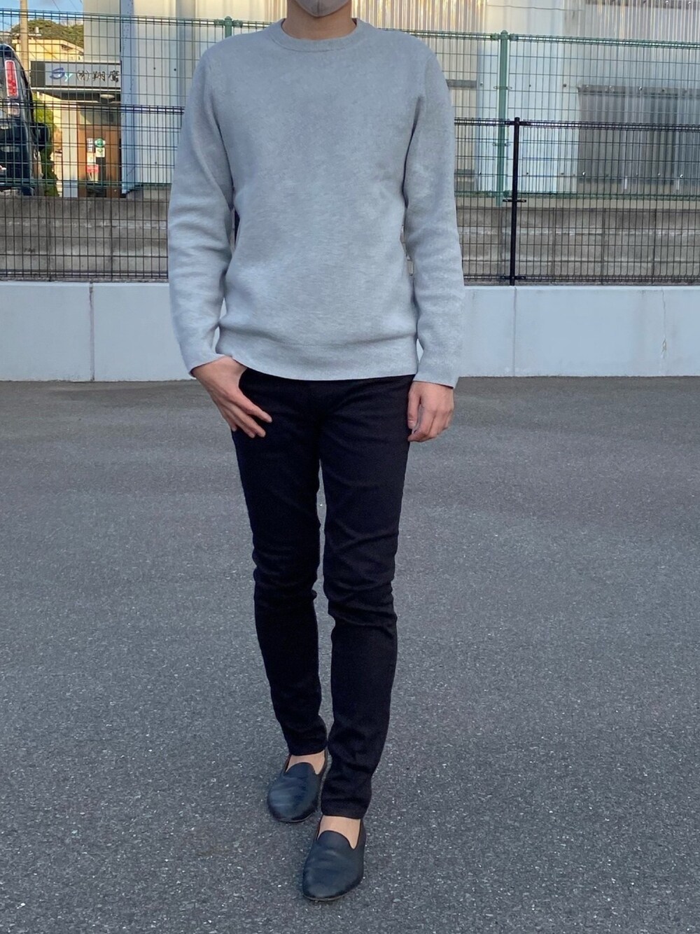 グレー系のニット/セーター、ブラック系のパンツ、ブラック系のスリッポンを着用したメンズの冬コーディネートの1枚目の写真