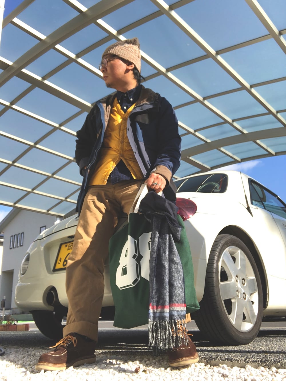 ブルー系のマウンテンパーカー、ベージュ系のベスト、ブルー系のシャツ/ブラウスを着用したメンズの冬コーディネートの1枚目の写真